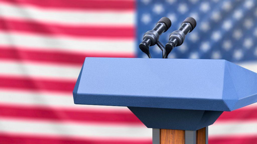 Image of a podium against an American flag background, representing post debate results